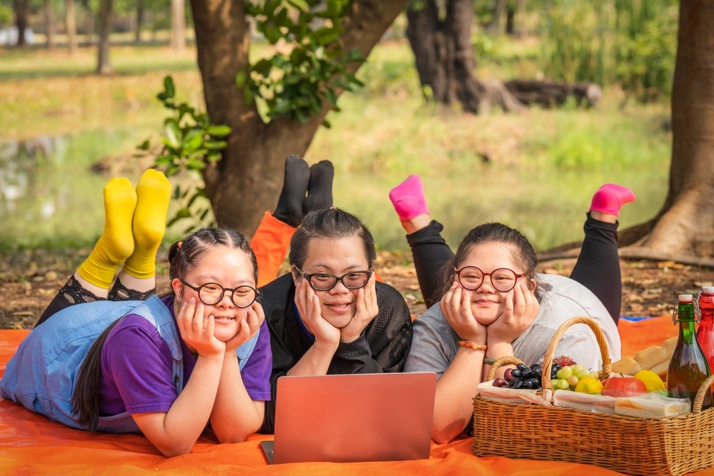Three disabled friends having picnic in park